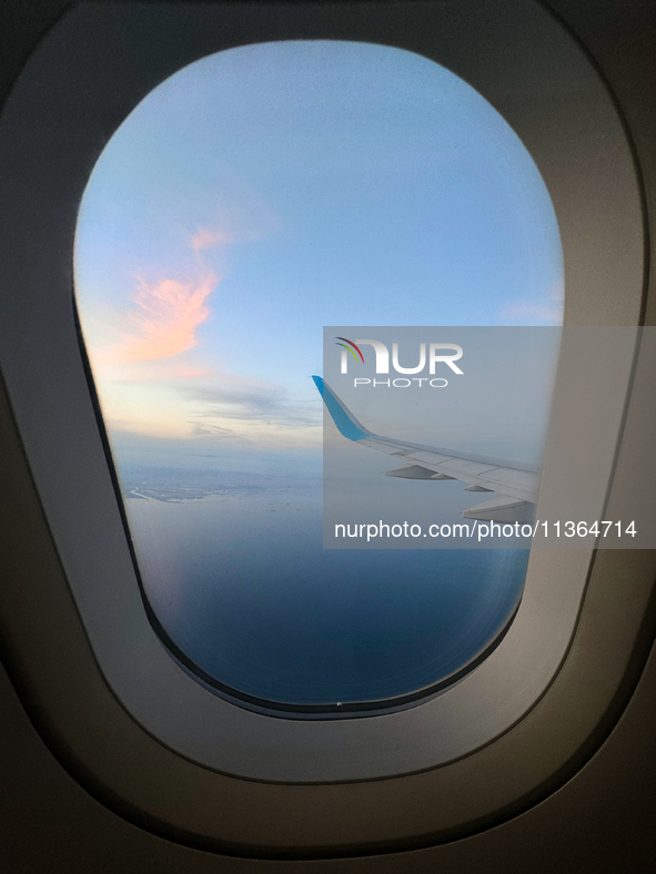 Clouds are appearing on the horizon, viewed from the window of an Airbus A321 from Vueling Airlines in Zurich, Switzerland, on June 27, 2024...