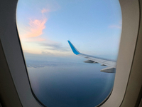 Clouds are appearing on the horizon, viewed from the window of an Airbus A321 from Vueling Airlines in Zurich, Switzerland, on June 27, 2024...