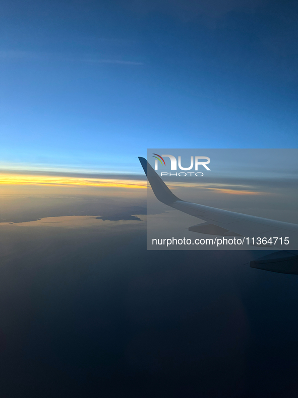 Clouds are appearing on the horizon, viewed from the window of an Airbus A321 from Vueling Airlines in Zurich, Switzerland, on June 27, 2024...