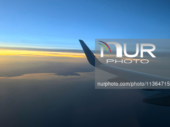 Clouds are appearing on the horizon, viewed from the window of an Airbus A321 from Vueling Airlines in Zurich, Switzerland, on June 27, 2024...