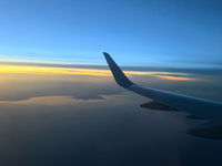 Clouds are appearing on the horizon, viewed from the window of an Airbus A321 from Vueling Airlines in Zurich, Switzerland, on June 27, 2024...