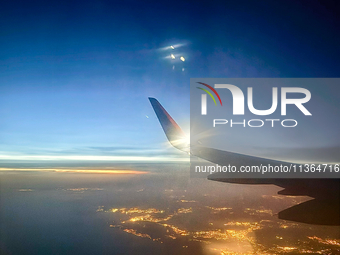 Clouds are appearing on the horizon, viewed from the window of an Airbus A321 from Vueling Airlines in Zurich, Switzerland, on June 27, 2024...