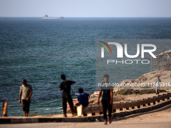 A ship is being pictured off the coast of Gaza near a temporary floating pier anchored by the United States to boost aid deliveries, as seen...