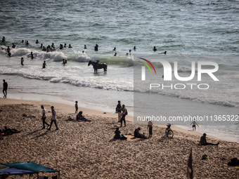 Palestinians are gathering on the beach in Nuseirat in the central Gaza Strip on June 27, 2024, amid ongoing cross-border tensions as fighti...