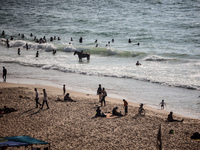 Palestinians are gathering on the beach in Nuseirat in the central Gaza Strip on June 27, 2024, amid ongoing cross-border tensions as fighti...