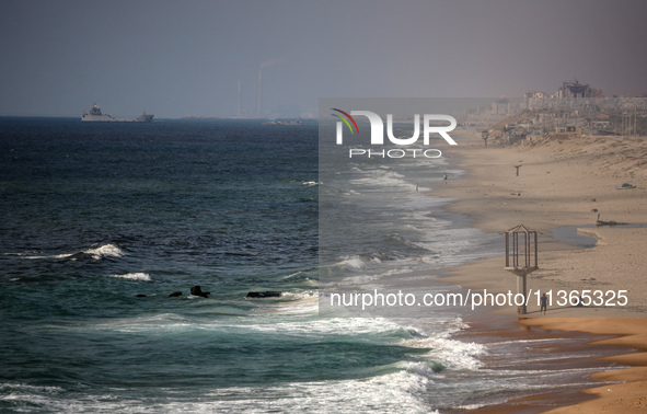 A ship is being pictured off the coast of Gaza near a temporary floating pier anchored by the United States to boost aid deliveries, as seen...