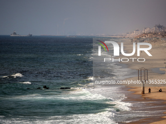 A ship is being pictured off the coast of Gaza near a temporary floating pier anchored by the United States to boost aid deliveries, as seen...