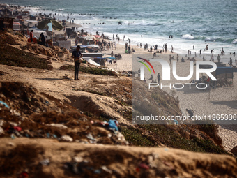 Palestinians are gathering on the beach in Nuseirat in the central Gaza Strip on June 27, 2024, amid ongoing cross-border tensions as fighti...