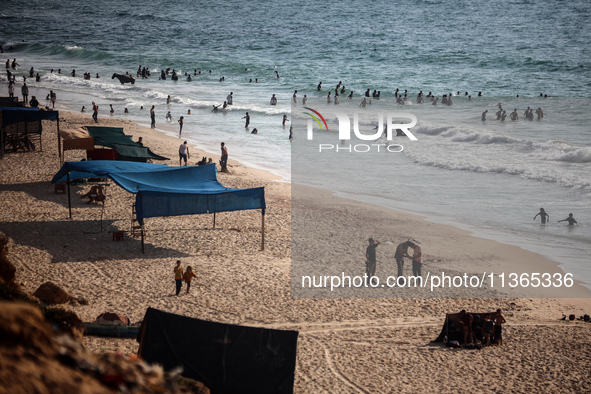 Palestinians are gathering on the beach in Nuseirat in the central Gaza Strip on June 27, 2024, amid ongoing cross-border tensions as fighti...