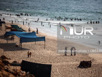 Palestinians are gathering on the beach in Nuseirat in the central Gaza Strip on June 27, 2024, amid ongoing cross-border tensions as fighti...