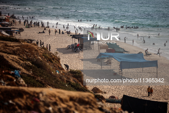 Palestinians are gathering on the beach in Nuseirat in the central Gaza Strip on June 27, 2024, amid ongoing cross-border tensions as fighti...