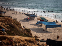 Palestinians are gathering on the beach in Nuseirat in the central Gaza Strip on June 27, 2024, amid ongoing cross-border tensions as fighti...