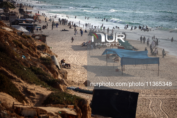 Palestinians are gathering on the beach in Nuseirat in the central Gaza Strip on June 27, 2024, amid ongoing cross-border tensions as fighti...