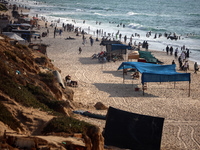 Palestinians are gathering on the beach in Nuseirat in the central Gaza Strip on June 27, 2024, amid ongoing cross-border tensions as fighti...