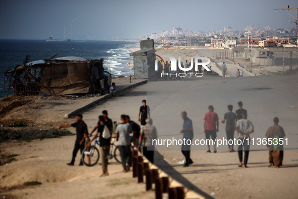 A ship is being pictured off the coast of Gaza near a temporary floating pier anchored by the United States to boost aid deliveries, as seen...