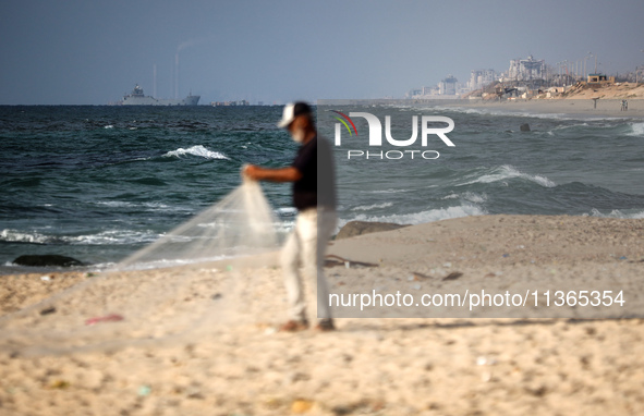 A ship is being pictured off the coast of Gaza near a temporary floating pier anchored by the United States to boost aid deliveries, as seen...