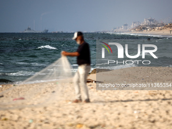 A ship is being pictured off the coast of Gaza near a temporary floating pier anchored by the United States to boost aid deliveries, as seen...