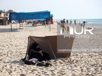 Palestinians are gathering on the beach in Nuseirat in the central Gaza Strip on June 27, 2024, amid ongoing cross-border tensions as fighti...