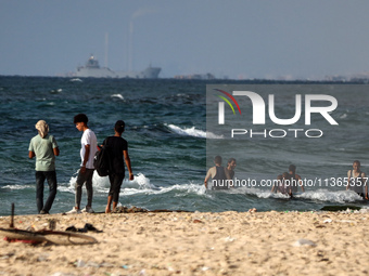 A ship is being pictured off the coast of Gaza near a temporary floating pier anchored by the United States to boost aid deliveries, as seen...