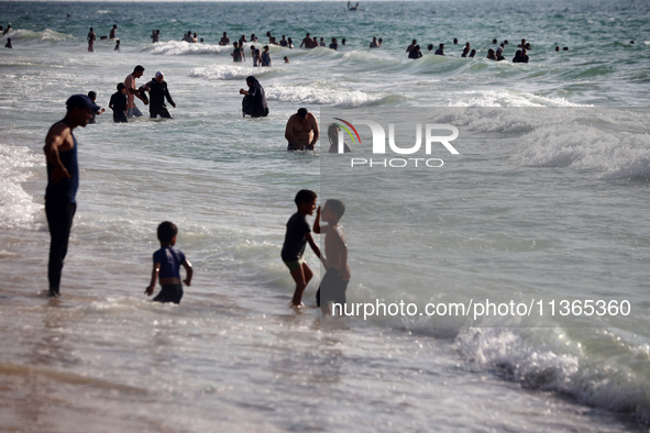 Palestinians are gathering on the beach in Nuseirat in the central Gaza Strip on June 27, 2024, amid ongoing cross-border tensions as fighti...