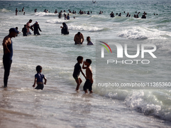 Palestinians are gathering on the beach in Nuseirat in the central Gaza Strip on June 27, 2024, amid ongoing cross-border tensions as fighti...