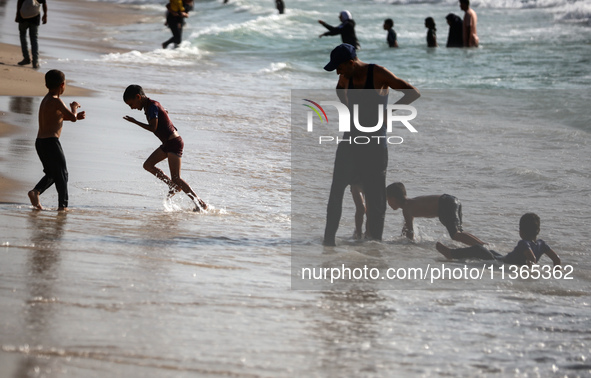 Palestinians are gathering on the beach in Nuseirat in the central Gaza Strip on June 27, 2024, amid ongoing cross-border tensions as fighti...