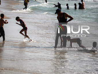 Palestinians are gathering on the beach in Nuseirat in the central Gaza Strip on June 27, 2024, amid ongoing cross-border tensions as fighti...