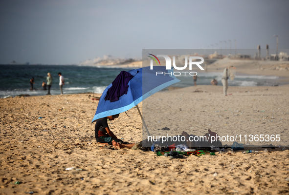 Palestinians are gathering on the beach in Nuseirat in the central Gaza Strip on June 27, 2024, amid ongoing cross-border tensions as fighti...