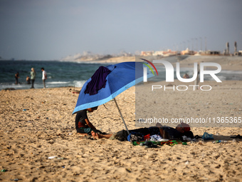 Palestinians are gathering on the beach in Nuseirat in the central Gaza Strip on June 27, 2024, amid ongoing cross-border tensions as fighti...