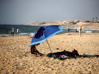 Palestinians are gathering on the beach in Nuseirat in the central Gaza Strip on June 27, 2024, amid ongoing cross-border tensions as fighti...