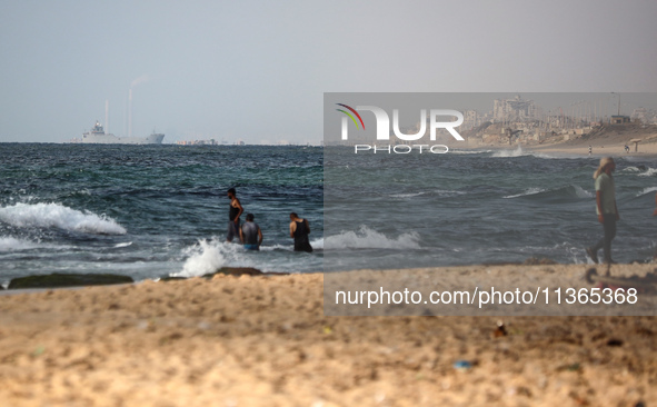 A ship is being pictured off the coast of Gaza near a temporary floating pier anchored by the United States to boost aid deliveries, as seen...