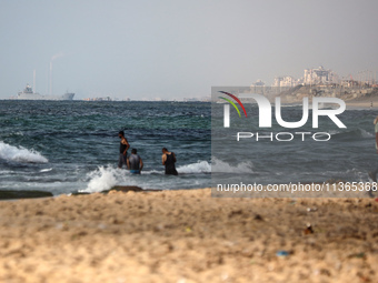 A ship is being pictured off the coast of Gaza near a temporary floating pier anchored by the United States to boost aid deliveries, as seen...