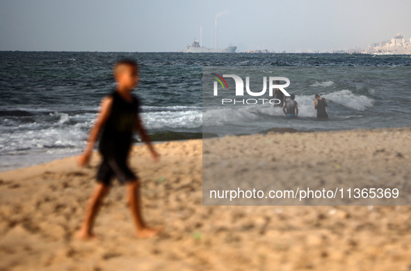 A ship is being pictured off the coast of Gaza near a temporary floating pier anchored by the United States to boost aid deliveries, as seen...