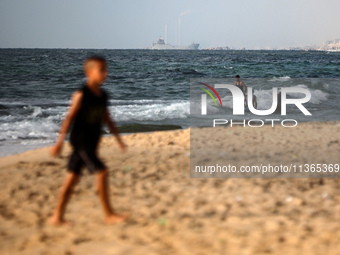 A ship is being pictured off the coast of Gaza near a temporary floating pier anchored by the United States to boost aid deliveries, as seen...