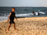 A ship is being pictured off the coast of Gaza near a temporary floating pier anchored by the United States to boost aid deliveries, as seen...