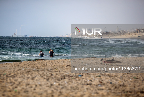 A ship is being pictured off the coast of Gaza near a temporary floating pier anchored by the United States to boost aid deliveries, as seen...