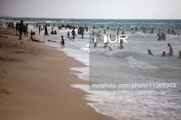 Palestinians are gathering on the beach in Nuseirat in the central Gaza Strip on June 27, 2024, amid ongoing cross-border tensions as fighti...