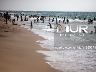 Palestinians are gathering on the beach in Nuseirat in the central Gaza Strip on June 27, 2024, amid ongoing cross-border tensions as fighti...