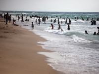 Palestinians are gathering on the beach in Nuseirat in the central Gaza Strip on June 27, 2024, amid ongoing cross-border tensions as fighti...