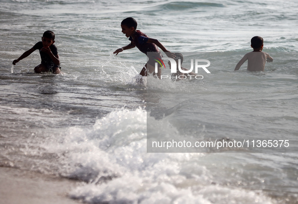 Palestinians are gathering on the beach in Nuseirat in the central Gaza Strip on June 27, 2024, amid ongoing cross-border tensions as fighti...