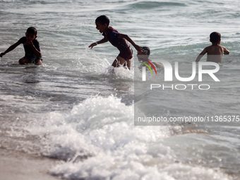 Palestinians are gathering on the beach in Nuseirat in the central Gaza Strip on June 27, 2024, amid ongoing cross-border tensions as fighti...