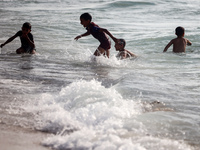 Palestinians are gathering on the beach in Nuseirat in the central Gaza Strip on June 27, 2024, amid ongoing cross-border tensions as fighti...