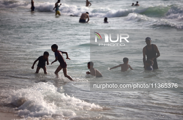 Palestinians are gathering on the beach in Nuseirat in the central Gaza Strip on June 27, 2024, amid ongoing cross-border tensions as fighti...