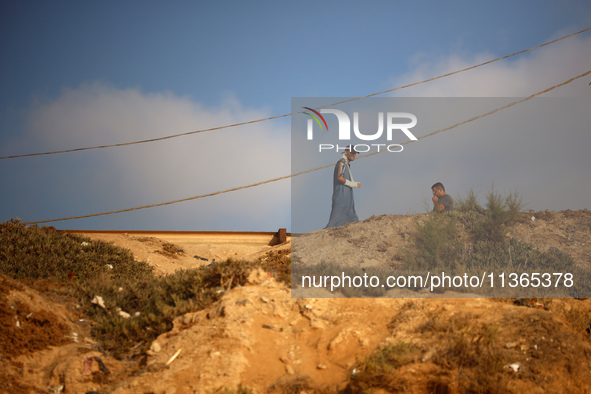 Palestinians are gathering on the beach in Nuseirat in the central Gaza Strip on June 27, 2024, amid ongoing cross-border tensions as fighti...