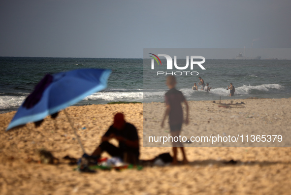 A ship is being pictured off the coast of Gaza near a temporary floating pier anchored by the United States to boost aid deliveries, as seen...