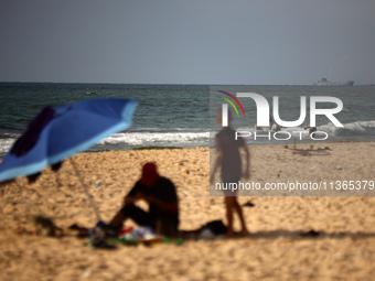 A ship is being pictured off the coast of Gaza near a temporary floating pier anchored by the United States to boost aid deliveries, as seen...