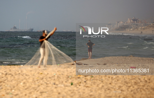 A ship is being pictured off the coast of Gaza near a temporary floating pier anchored by the United States to boost aid deliveries, as seen...