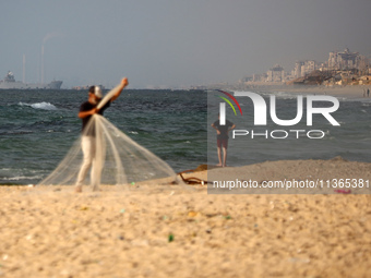 A ship is being pictured off the coast of Gaza near a temporary floating pier anchored by the United States to boost aid deliveries, as seen...