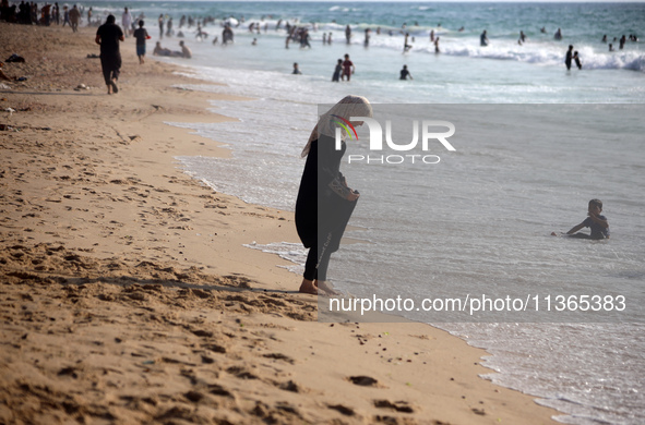 Palestinians are gathering on the beach in Nuseirat in the central Gaza Strip on June 27, 2024, amid ongoing cross-border tensions as fighti...