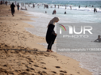 Palestinians are gathering on the beach in Nuseirat in the central Gaza Strip on June 27, 2024, amid ongoing cross-border tensions as fighti...